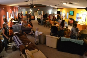 People stand to sing songs of worship facing the side wall.